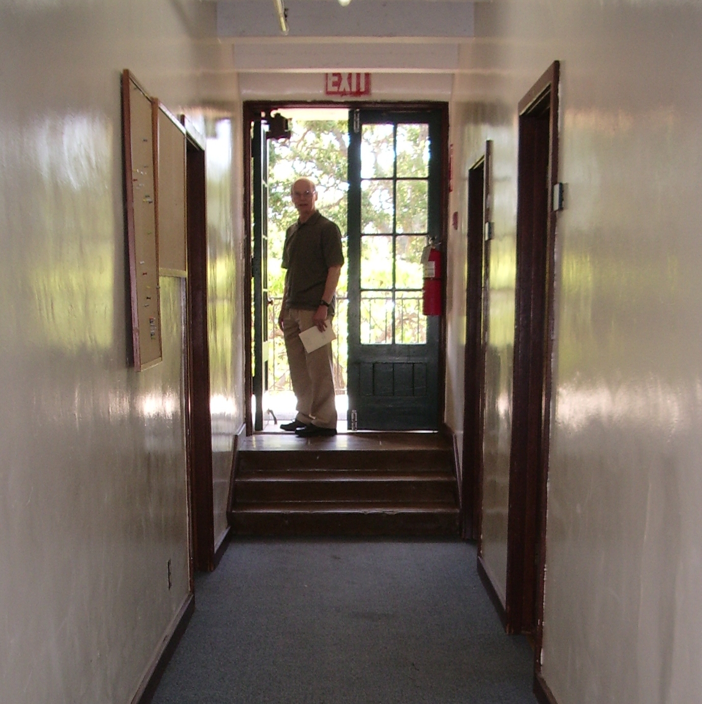 a man standing in doorway of his old high school. photo by bf newhall