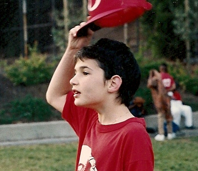 Peter Newhall lifts his Reds baseball cap during Piedmont CA rec department game. Photo 1991 by BF Newhall