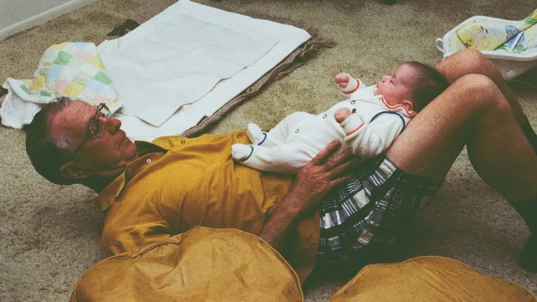 father's day vs. mother's day father-playing-with-grandson