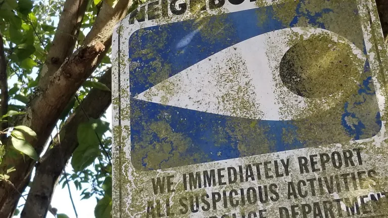 those people and a neighborhood-watch-sign
