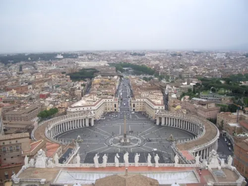 A statue of a glorious Christ is flanked by 11 of the apostles atop a grand facade overlooking St. Peter's Square, Rome. Photo by Barbara Newhall