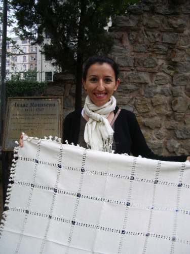In an Istanbul park, a street vendor offers a handwoven cloth with blue beads to a tourist. Photo by Barbara Newhall