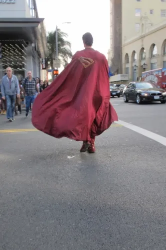 christopher-Dennis-superman-cape Actor Christopher Dennis dressed as Superman crosses Holllywood street cape billowing. Photo by BF Newhall