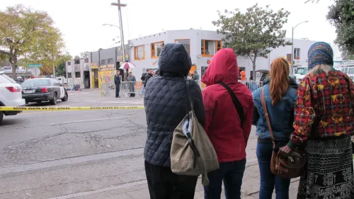 Visitors at the scene of the Oakland Ghost Ship fire that killed 36 young people. A few days after the fire, it was cordoned off as a "crime scene." Photo by Barbara Newhall