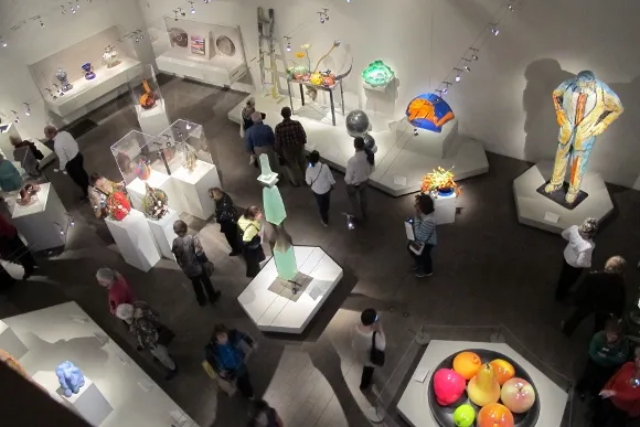 Bouquets to Art show at the de Young Fine Arts Museum, San Francisco showing room of glass and ceramic art with floral arrangements, including glass by Dale Chihuly, top right, and bouquet by Bonnie Hart.. Photo by BF Newhall