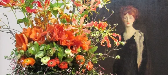 Kaori Imaizumi of Blooming Floral Design, Inc., created a floral design for Henri's "Lady in Black with Spanish Scarf." Photo by BF Newhall