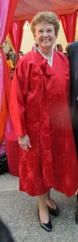 A woman of European ancestry wearing a bulky red brocade kimono. BF Newhall photo