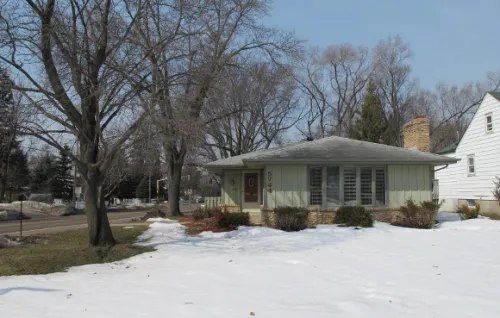 edina-houses Midcentury traditional house with snow and bare trees. Photo by BF Newhall