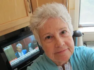 Barbara Falconer Newhall in her bathrobe and pajamas keeping up with the Christine Blasey Ford and Brett Kavanaugh news on the day Jeff Flake called for an FBI investigation. Photo by Barbara Newhall