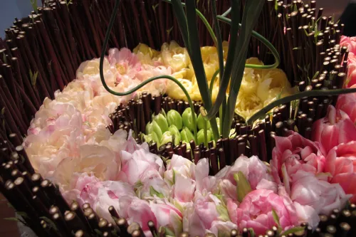 For the De Young Museum's Bouquets to Art show, a flat floral design by Poppy's Petalworks, San Francisco. Painting "Tulip Culture," by George Hitchcock. Photo by Barbara Newhall.