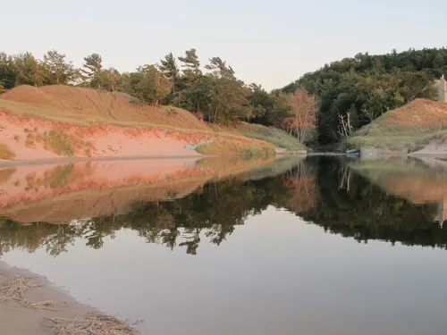 Sunset light reflected on a channel leading into Lake Michigan near Ludington. Photo b Barbara Newhall Barbara Falconer Newhall travels up and down Michigan's lower peninsula, visiting friends and family and putting on book events for "Wrestling with God."
