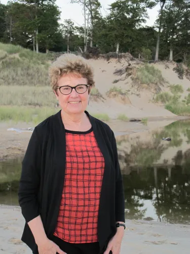 Barbara Falconer Newhall, author of Wrestling with God, is photographed on a Lake Michigan beach. Barbara Falconer Newhall travels up and down Michigan's lower peninsula, visiting friends and family and putting on book events for "Wrestling with God."