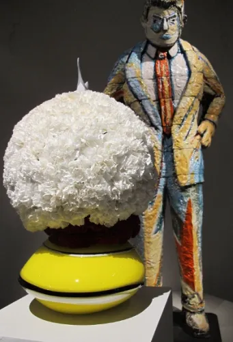 Round floral arrangement of white carnations by Ricardo Aguilar of VelaFlor, San Francisco. ceramic sculpture by Viola Frey, "Man Ob