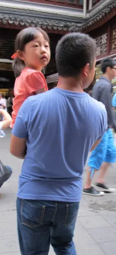 In Shanghai a man holds his preschool age daughter in his arms. Photo by bf newhall
