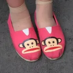 monkey-espadrilles bright pink espadrille shoes with funny monkey faces on a girl in Shanghai. Photo by BF Newhall