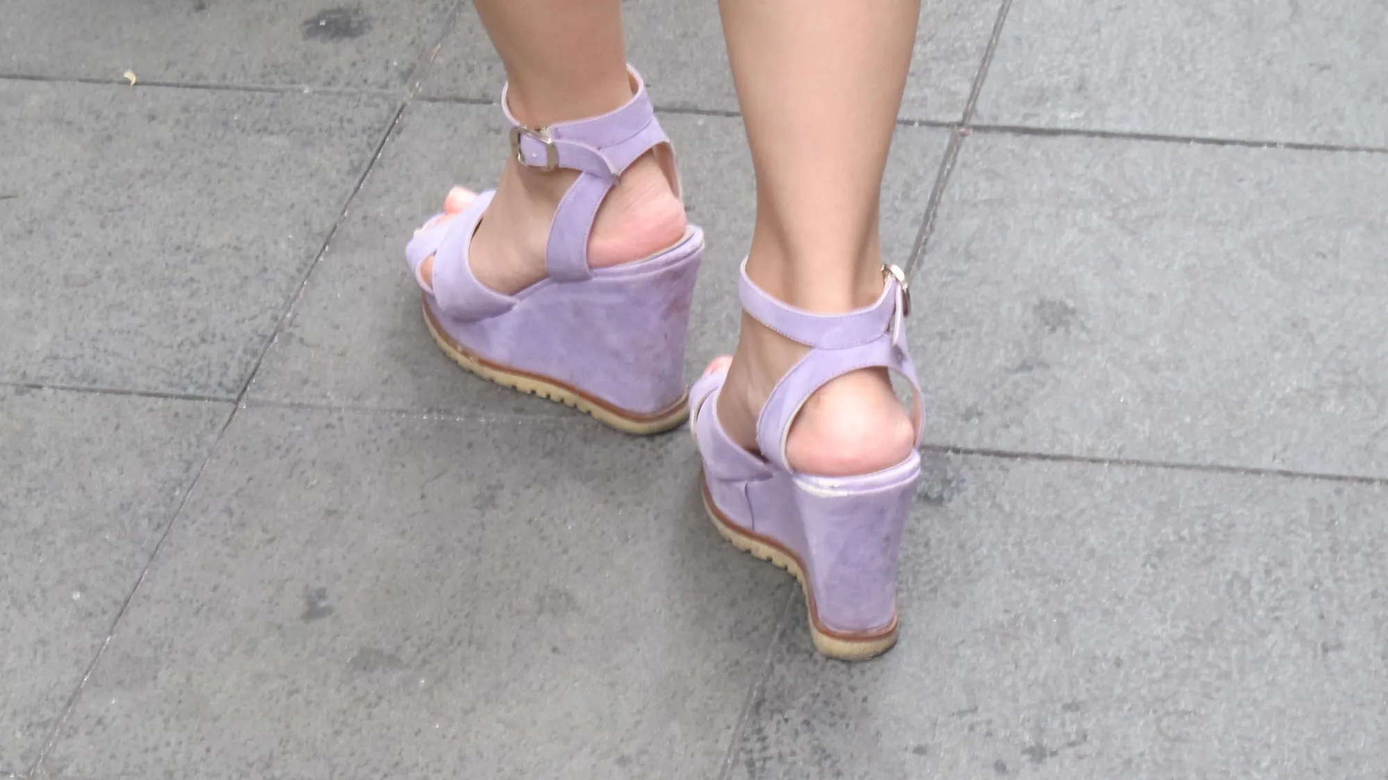 Super high -- feminine? -- wedge-heeled shoes worn by a woman in Shanghai. Photo by Barbara Newhall