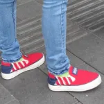 A Shanghai girl wears jeans and slip on sneakers with stars and stripes of the American flag. Photo by BF Newhall