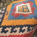 A brightly colored geometric Anatolian handwoven carpet with gold, blue, red, black and white elements on sale for $400 at the Himalayan Fair, Berkeley CA, 2014. Photo by BF Newhall