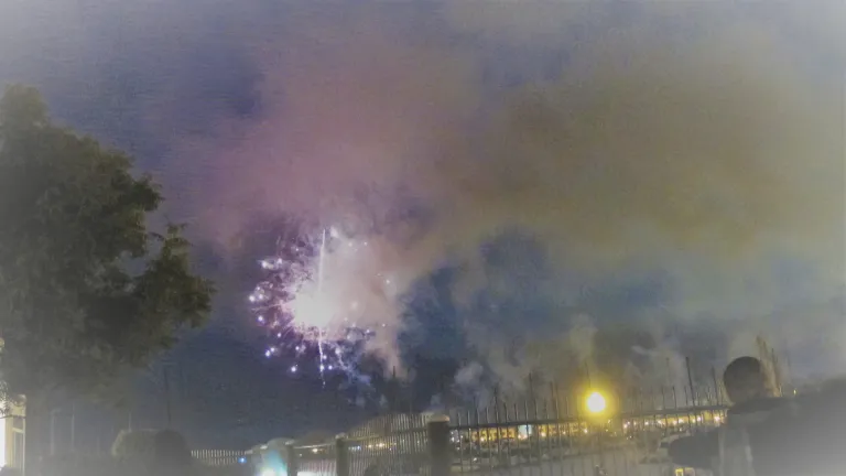American flag flies and fireworks explode on July 3, 2017, in preparation for the Fourth of July. Photo by Barbara Newhall