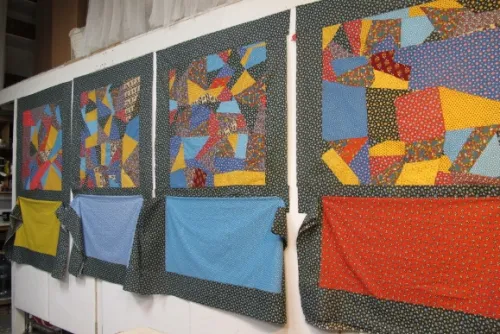Four crazy quilts of mid-twentieth century flowered calico in primary colors are being assembled in the studio of Sue Mary Fox, Berkeley, California. Designed by Barbara Falconer Newhall. Photo by Barbara Newhall