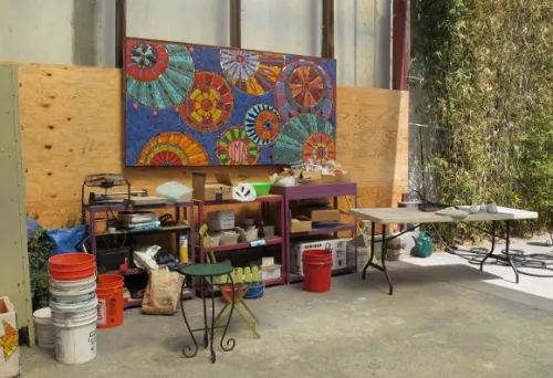 institute-of-mosaic-art The workroom of the Iinstitute of Mosaic Art, Berkeley, CA, with open garage door and mosaic by Laurel True's 2013 summer mural class. Photo by BF Newhall