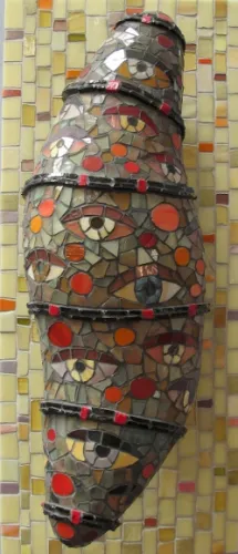 Wilma-Wyss A three-dimensionalgreenish mosaic, "Gazing Cocoon,." by Wilma Wyss on display at the Institute of Mosaic Art, Berkeley, represents a cocoon with eyeballs looking out. Photo by BF Newhall