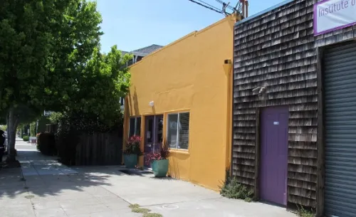 institute-of-mosaic-art Allston Way entrance to the Institute of Mosaic art with yellow and shingled facade and purple garage door. Photo by BF Newhall