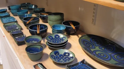 A shelf of Itsuko Zenitani's fine porcelain ceramic blue tableware on display at the Berkeley Potters Guild. Photo by BF Newhall 