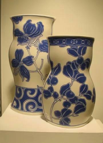 Sarah Gregory ceramics, at Potters Guild, Berkeley, CA. Two white vases w blue floral painting by Sarah Gregory ceramics, at Berkeley Potters Guild, CA. . Photo by BF Newhall