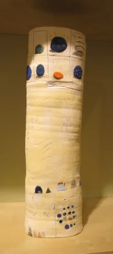 Tall, narrow whmsical handmade ceramic vase, tubular in shape by Dahli Tutman. At the Berkeley Potters Guild, Berkeley, CA. Photo by BF Newhall