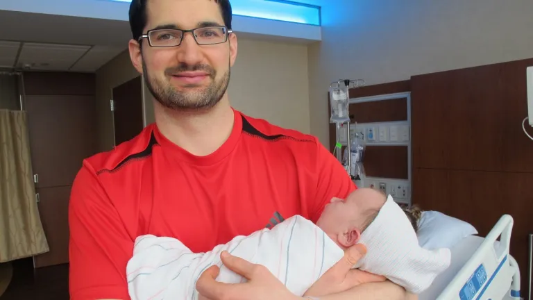 father's day vs. mother's day young-father-with -newborn