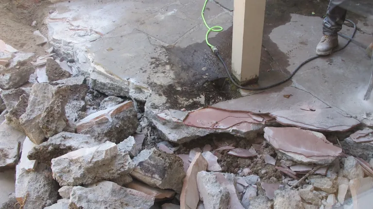 jackhammering-concrete in a shabby old patio