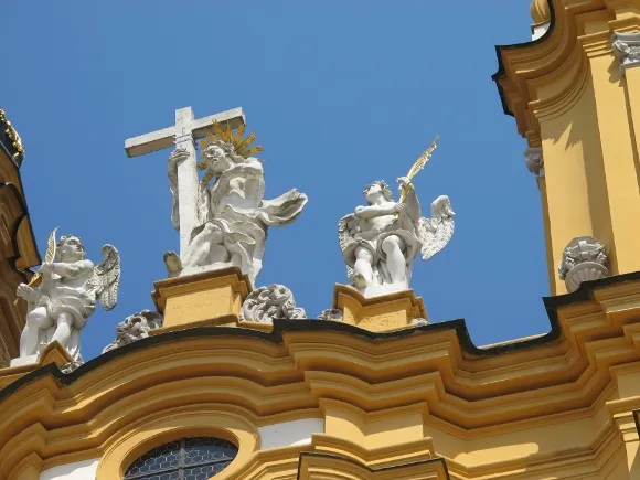 At the baroque Melk Abby, Austria.A white statue of the risen Christ with a cross over the entrance. Photo by Barbara Newhall.