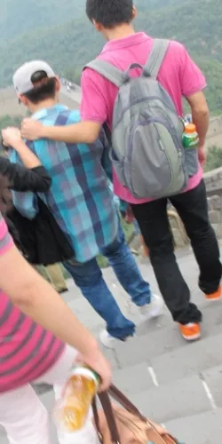 A teenaged boy climbs the Great Wall of China with a man who seems to be his father. Photo by BF Newhall
