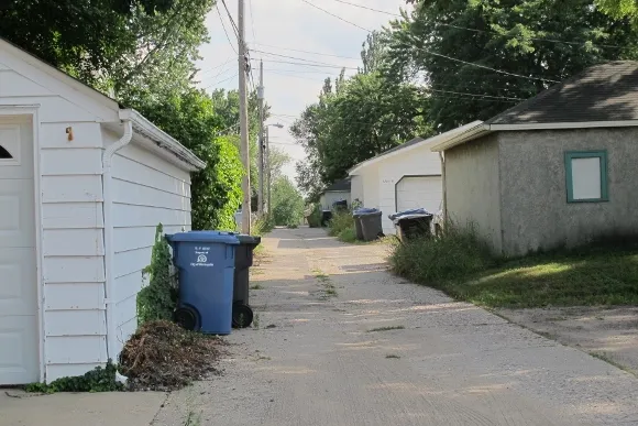The alley behinda street full of tidy looking Tudors, so that access to garages is from this ally, leaving the street view of the neighborhood free of driveways and massive garage doors. Photo by Barbara Newhall