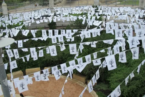 As part of the THIRST temporary art installation, hundreds of prayer flags hang from the circular path from the pedestrian bridge down to Lady Bird Lake in Austin. Photo by BF Newhall