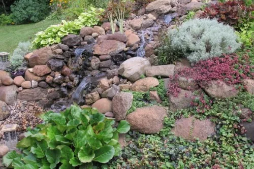 A man-made waterfall on a garden slope in Minnesota. Photo by Barbara Newhall