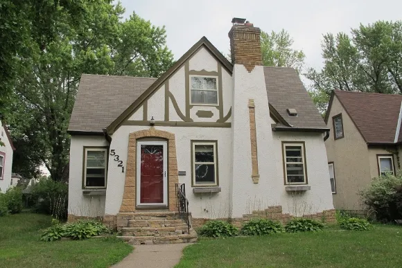 A grey-green Tudor bungalow in Minneapolis. Photo by Barbara Newhall A grey-green Tudor bungalow in Minneapolis. Photo by Barbara Newhall