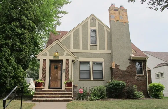 A grey-green Tudor bungalow in Minneapolis. Photo by Barbara Newhall