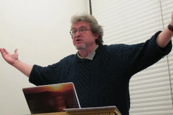 Author phil cousineau at the podium speaking to a 1-6-2014 Left Coast Writers meeting at Book Passage, Corte Madera, about his new book, "Burning the Midnight Oil" Photo by Barbara Newhall