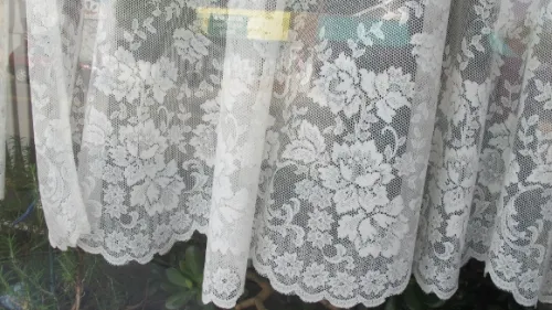 Victorian style white curtain in a Pentwater, Michigan, window. Photo by BF Newhall