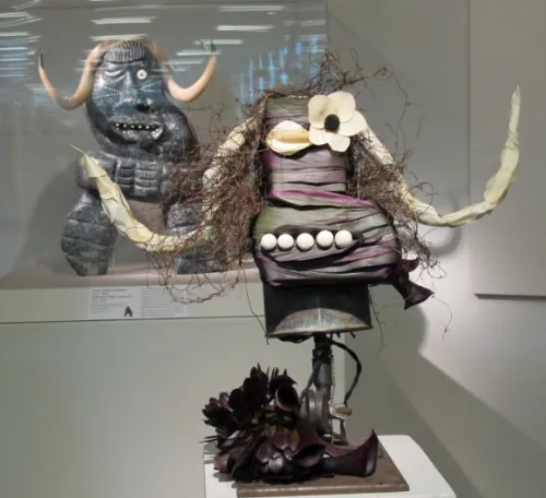 A floral design by Arlene Boyle of Violetta, SF, was inspired by a soapstone and walrus tusk carving by Judas Ullulak (Allulak), "Inukshuk" (Like a Person), 1981-82. Photo by BF Newhall