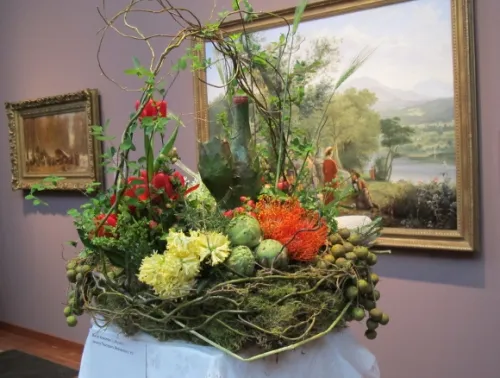 Floral designer Dariel Alexander of Lafayette, CA, created a bucolic flower arrangement inspired by Jerome Thompson's 1857 painting of a picnic "Recreation"
