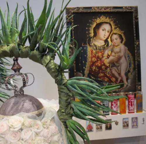 Nicole vidalakis of the san francisco garden club used spray roses and intertwined leaves in her floral arrangement complementing an image of Virgin and Child. Photo by BF Newhall