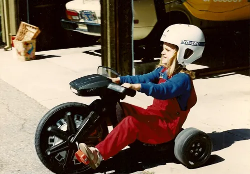 girl on tricyclle with helmet. Photo by Barbara Newhall