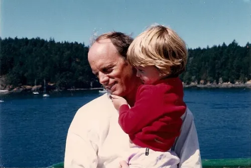 Men and housework and childcare. A man carries his affectionate toddler girl. Photo by Barbara Newhall