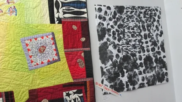 art-quilts-by-Donna-Duguay A colorful assymetrical art quilt and a quilt with black fleurs du mal against a white background by Donna Duguay of Berkeley, CA. Photo by BF Newhall