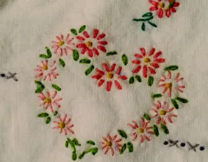 grandmother's-embroidered-pillowcase-hearts-french-knot Mid 2oth century hand embroidered pillowcase with pink hearts. Photo by BF Newhall