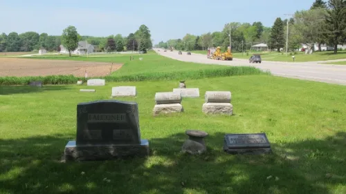 Brookside Cemetery in Amber Township, west of Scottville, MI. Headstones in foreground, farmland and busy Highway 10 in background. Photo by BF Newhall