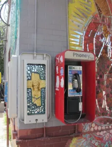 A mural dipicting Jesus on the cross is painted on an fuse box next to a telephone at a convenience store in east Austin, TX. Photo by BF Newhall